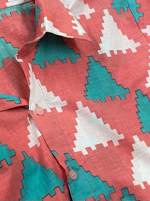 Peach Puzzle Summer Shirt, featuring a pattern of blue and white triangles. Closeup. 