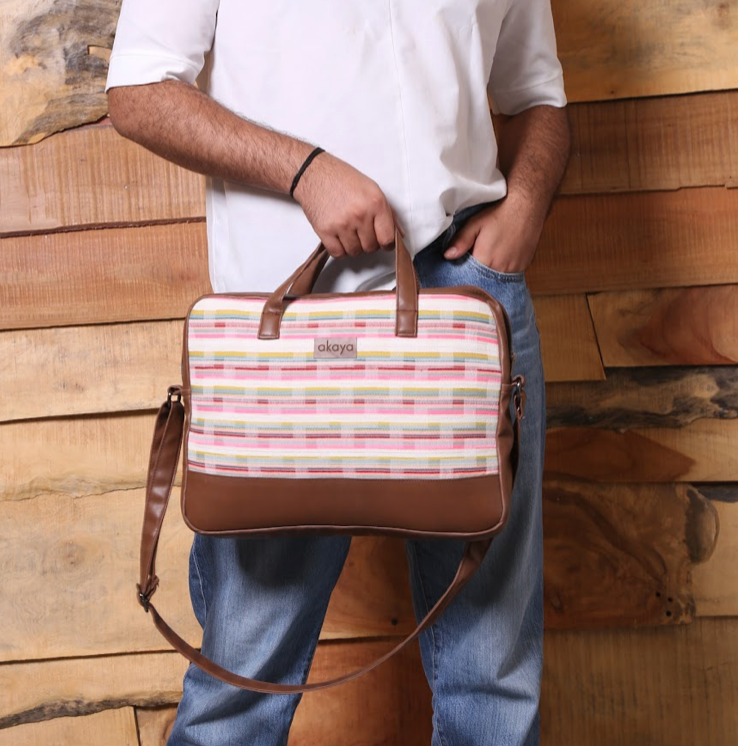 COTTAGE STRIPES MESSENGER BAG/ laptop bag, leather on sides, bottom and handles, man holding with handles 